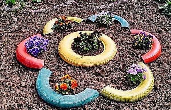 Canteiro de flores de camomila de pneus