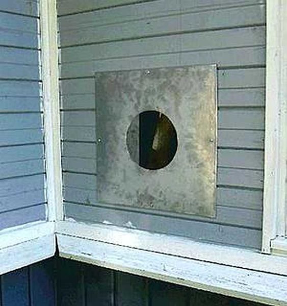This is how a pipe passage through a wall, sealed with a sheet of metal, looks like