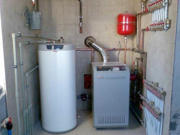 Floor standing gas boiler and storage boiler nearby