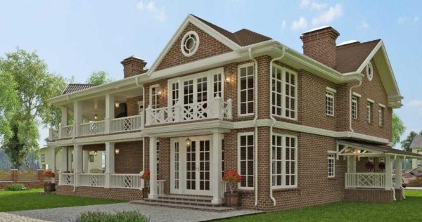 Gran casa de ladrillo de dos pisos con dos terrazas abiertas con elementos Art Nouveau